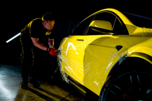 3M wrap specialist  is adjusting wrap while displaying how to to properly apply to your vehicle.